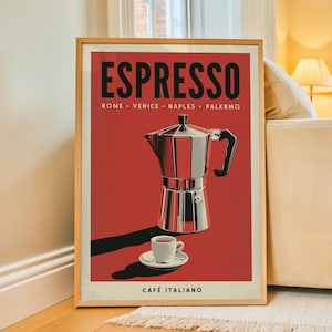 May include: A framed poster with a red background featuring a silver moka pot and a small white espresso cup on a saucer. The text reads ESPRESSO, ROME, VENICE, NAPLES, PALERMO, and CAFÉ ITALIANO in black and white lettering with a light wood frame.