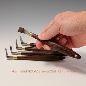 May include: Set of five heat-treated 420J2 stainless steel pottery trimming tools with wooden handles. The tools have different shaped blades for trimming and shaping clay.
