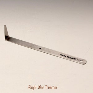 May include: A silver metal tool with a pointed end and a hole at the other end. The tool is labeled "Hein Tools #17" and "Right Wet Trimmer".