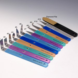 May include: A set of 15 blue and silver tools with numbered handles, labeled "Hair Tools" and a diamond file labeled "Diamond File".