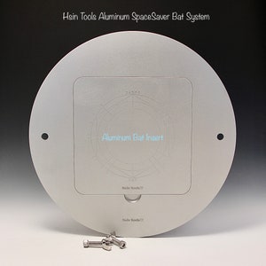 May include: A silver circular aluminum plate with a square cutout in the center. The cutout has a circular design with numbers and the text "Aluminum Bat Insert". The plate has the text "Hsin Tools" printed on it. Three silver screws are visible below the plate.