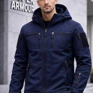 May include: A navy blue hooded jacket with multiple zipped pockets and a black zip closure. The jacket features a hood and the words "SUPER ARMOUR" are visible in the background.