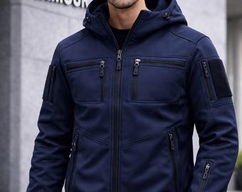 May include: Navy blue hooded jacket with multiple zippered pockets and a black zipper closure. The jacket has a hood and the words "SUPER ARMOUR" are visible in the background.