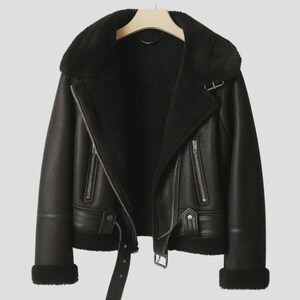 May include: Black faux leather jacket with a shearling collar and lining. The jacket features a zip closure, a belt at the waist, and zip pockets. The cuffs are trimmed with shearling. The jacket is hanging on a wooden hanger.