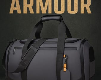 May include: A gray duffel bag with black accents, a top handle, and a shoulder strap. The bag has a zipper closure and a luggage tag. The words "SUPER ARMOUR" are printed in gold letters above the bag.