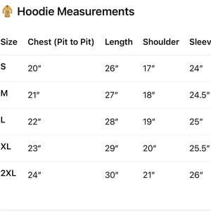 May include: A white chart titled "Hoodie Measurements" displays size, chest (pit to pit), length, shoulder, and sleeve measurements in inches. Sizes range from S to 2XL, with corresponding measurements for each.