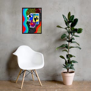 May include: Abstract art print featuring a colorful, geometric face design. The artwork includes a black frame, with a white chair and a potted plant in the background. The face is composed of various shapes and colors, including blue, yellow, red, and black.