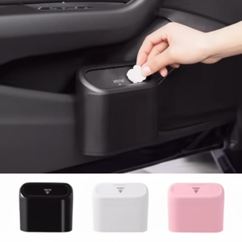 May include: A black car trash can installed in a vehicle's door. The can is rectangular with a small opening and the word "WINE" printed on the top. Additional cans in white and pink are shown below.