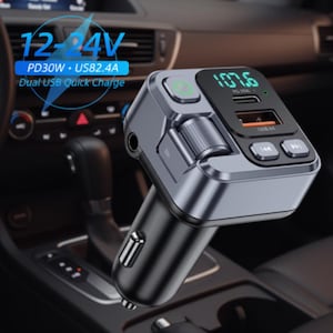 May include: A black and silver car charger with a digital display showing 107.6. The charger has two USB ports and a green power button. Text on the charger reads "12-24V", "PD30W + US82.4A", and "Dual USB Quick Charge".