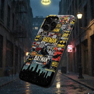 May include: A black phone case featuring a collage of Batman-themed graphics and logos. The design includes the Batman logo, comic book-style text, and a silhouette of Gotham City. The case is shown against a rainy street backdrop.