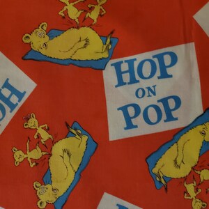 Dr Seuss Hop on Pop words and characters on red background cotton quilt fabric for Robert Kaufman