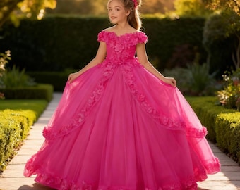 May include: A vibrant pink formal dress with floral embellishments. The off-the-shoulder bodice is adorned with 3D flowers, and the full skirt features cascading floral accents. The dress is made of a flowing, lightweight fabric, perfect for special occasions.