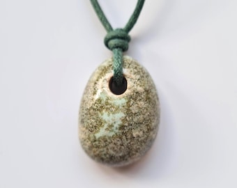 Clay hand formed pendant. Green tones. Custom cord colour and length.