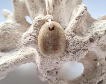 Clay hand formed pendant. Soft Sandy glaze. Custom cord colour and length.