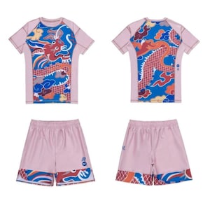 May include: A light pink athletic set, comprising a short-sleeved top and shorts. The garments display a dragon motif in blue, red, and yellow. The set is designed for athletic activities and is suitable for various sports.