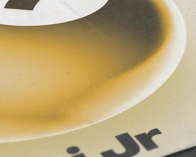 May include: Close-up of a design with a gradient of yellow and brown hues. The top features a white shape with a black outline. The text "Jr" is visible in black at the bottom.