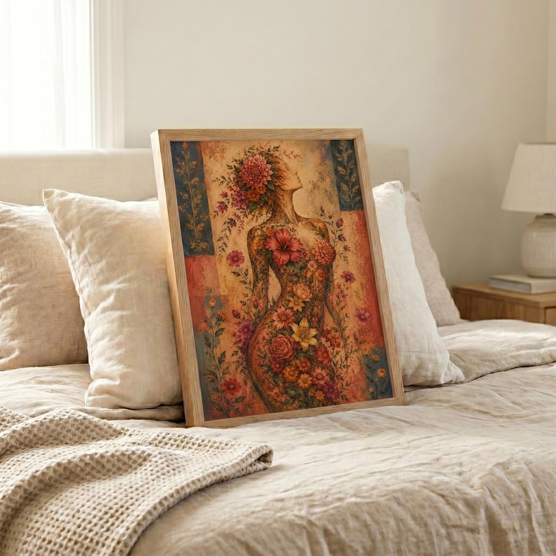 Framed floral woman wall art leaning against bedroom wall, boho botanical female figure print, warm earth tone bedroom decor