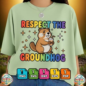May include: A pale green t-shirt featuring the phrase "RESPECT THE GROUNDHOG" in rainbow hues. A cartoon groundhog with a drink is in the center, surrounded by stars. File type icons are at the bottom.