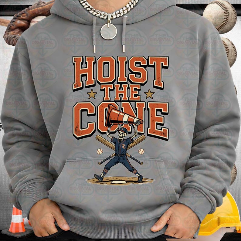May include: Gray hoodie with a graphic that says "HOIST THE CONE". The graphic features a skeleton baseball player holding a traffic cone, with baseball bats and balls. The hoodie has a drawstring hood.