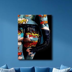 May include: A rectangular wall art print featuring a vibrant comic book pop art pattern with speech bubbles containing the words ZAP and POW. The design includes a black leather glove and a black lace trim against a dark background.