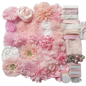 May include: A collection of pink and white fabric flowers, lace, and ribbon. The flowers are made of various materials, including satin, tulle, and lace. The ribbon is in a variety of widths and patterns. This set of embellishments is perfect for crafting hair accessories, headbands, and other projects.