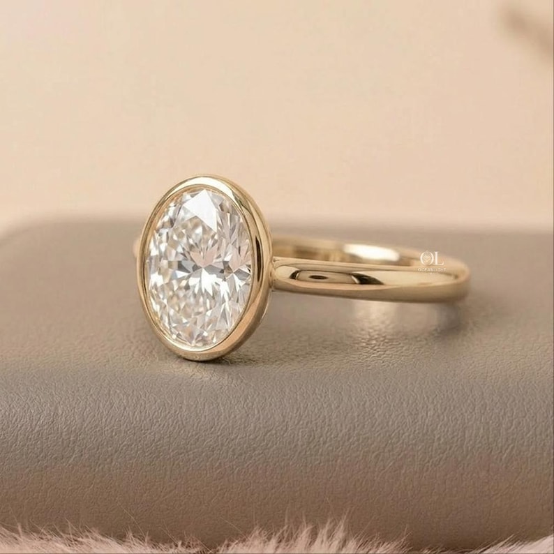 Oval solitaire gold bezel engagement ring for women