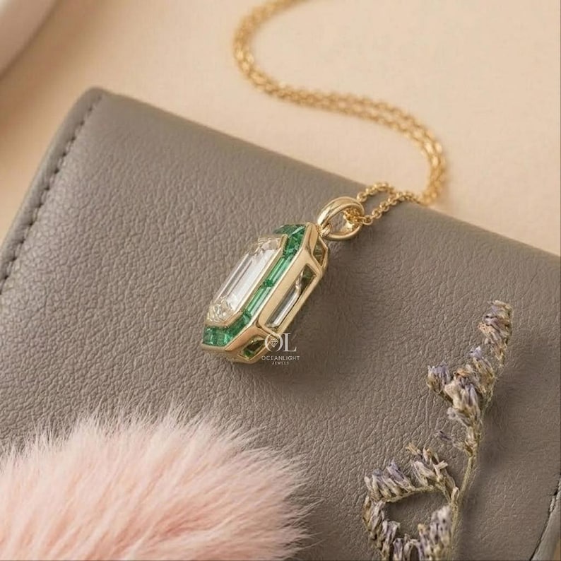 Green emerald halo pendant with a rectangular step cut center diamond for women's fine jewelry.