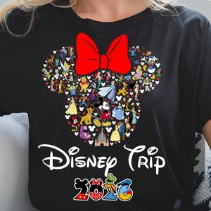 May include: Black t-shirt featuring a Mickey Mouse head shape filled with Disney characters and a large red bow. The words "Disney Trip 2023" are printed below the design in white and colorful lettering.
