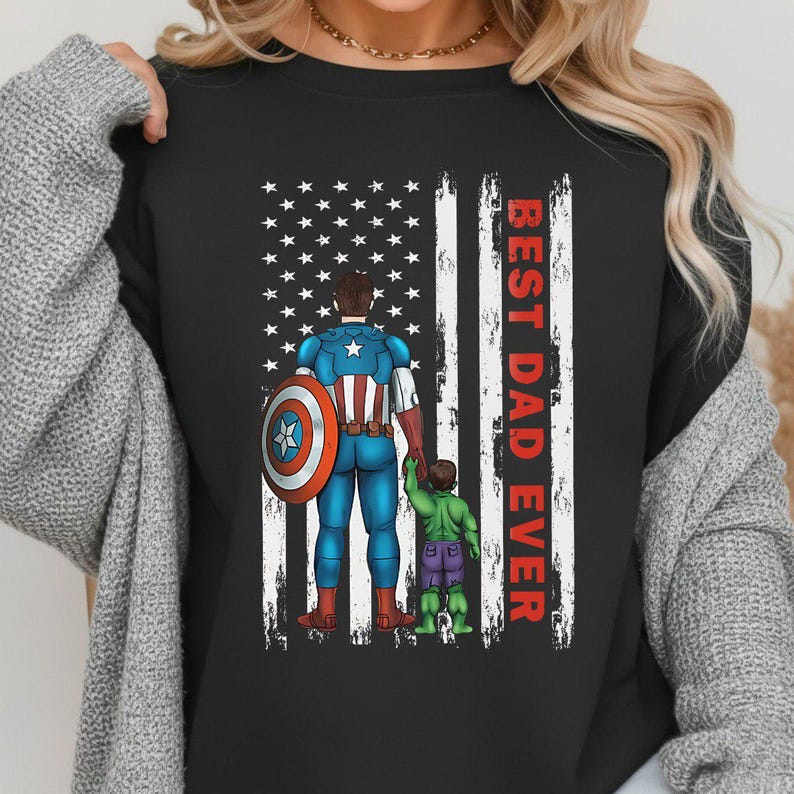May include: Black t-shirt featuring a graphic of Captain America holding hands with the Hulk in front of a distressed American flag. The words "BEST DAD EVER" are printed vertically in red.