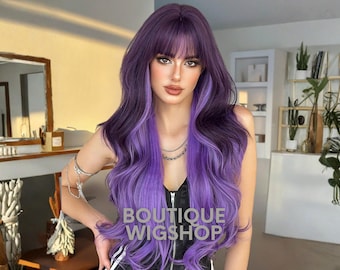 May include: A long, wavy wig in shades of purple, with a dark base and lighter highlights. The wig has a fringe and the text "BOUTIQUE WIGSHOP" in white. The hair is styled in loose waves.