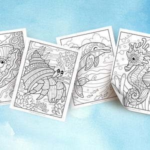 May include: Four black and white colouring pages featuring sea creatures. The pages include a clam, a hermit crab, a dolphin, and a seahorse.