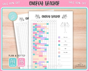 May include: Two white paper energy trackers with the title "ENERGY TRACKER" at the top. One tracker is filled with colored blocks, and the other is blank. The trackers have a grid for tracking energy levels. The image also includes the text "PLAIN & DOTTED", "A4 Letter", and "A5 journal".