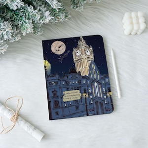 May include: A rectangular notebook featuring a dark blue night scene of Big Ben and the Houses of Parliament. A full moon shows silhouettes of figures flying. A speech bubble contains the text: "What if I fall? Oh, but my darling, what if you fly?"