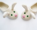 Two white bunnies. Felted kid size slippers product logo