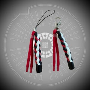 May include: Two braided lanyards with red, white, and black accents. Each lanyard has a black loop and a silver-coloured clasp. The braided section is approximately 7.6 cm long.