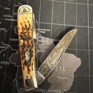 May include: A set of three ceramic mugs with a speckled, matte finish in cream, light grey, and dark grey. Each mug has a simple, minimalist design and a rounded handle.