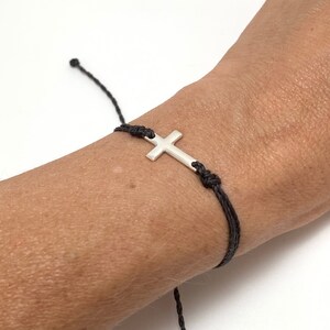 cross bracelet shown on a womans wrist