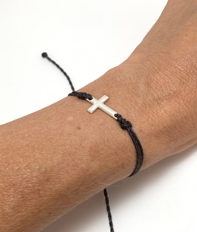 cross bracelet shown on a womans wrist