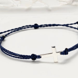 Silver cross with navy blue straps