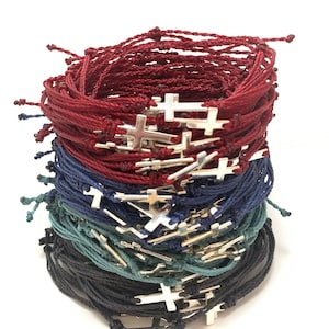 Cross bracelets shown in burgundy, navy blue, steel blue and black with silver crosses.