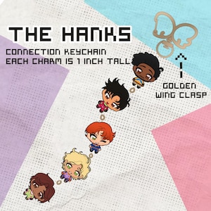 May include: The Hanks connection keychain features five chibi-style character charms, each 1 inch tall, linked together. The set includes a golden wing clasp. Text on the image reads: THE HANKS, CONNECTION KEYCHAIN, EACH CHARM IS 1 INCH TALL, GOLDEN WING CLASP.