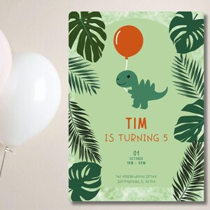 May include: A birthday invitation featuring a green dinosaur holding an orange balloon. The text "TIM IS TURNING 5" is displayed in orange. Green tropical leaves frame the design. The date and time are also included.