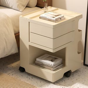 May include: A set of three ceramic mugs with a speckled, cream-colored glaze. Each mug features a different hand-painted design: a blue and green leaf, a yellow flower, and a red berry. The mugs have a simple, rounded shape.