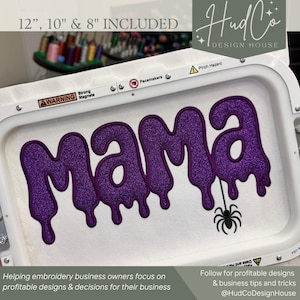 May include: An embroidery hoop frame containing white fabric with the word MAMA stitched in a purple glittery, dripping font style. A small black spider is embroidered hanging from the letter A. The frame includes warning labels and text 12, 10 & 8 INCLUDED.