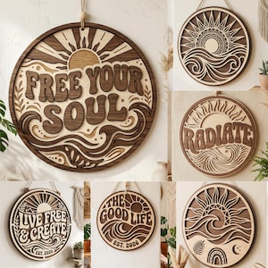 May include: A collection of wooden wall art with a layered design. The circular pieces feature sun, wave, and text designs, including "FREE YOUR SOUL," "RADIATE," "LIVE FREE & CREATE," and "THE GOOD LIFE." Each piece is made of light and dark wood.