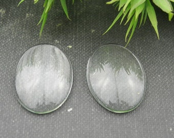 May include: Two clear glass oval cabochons, perfect for crafting jewelry or other projects.