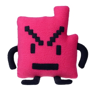 May include: A plush, pink, pixelated character pillow with black pixelated eyes, mouth, and eyebrows. It has black curved arms and small black feet. The pillow has a rectangular body with a rectangular extension at the top.