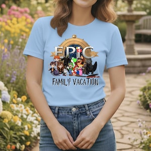 May include: Light blue t-shirt with the word "EPIC" above a graphic of cartoon characters and the words "FAMILY VACATION" below. The shirt features a round neck and short sleeves.