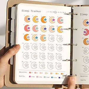 Könnte beinhalten: Eine Seite eines Schlaftagebuchs mit monatlichem Layout. Jeder Tag zeigt eine Halbmond- und Sternengrafik in verschiedenen Farben. Das Journal enthält einen Schlüssel für Schlafdauer und -qualität mit farbcodierten Bewertungen.