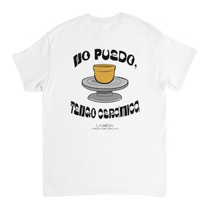 Puede incluir: Una camiseta blanca con un gráfico de una vasija de barro color canela sobre un torno de alfarero gris. El texto negro arriba y abajo dice "NO PUEDO, TENGO CERÁMICA." Debajo, un texto negro más pequeño dice "LA MESA LABORATORIO CREATIVO."